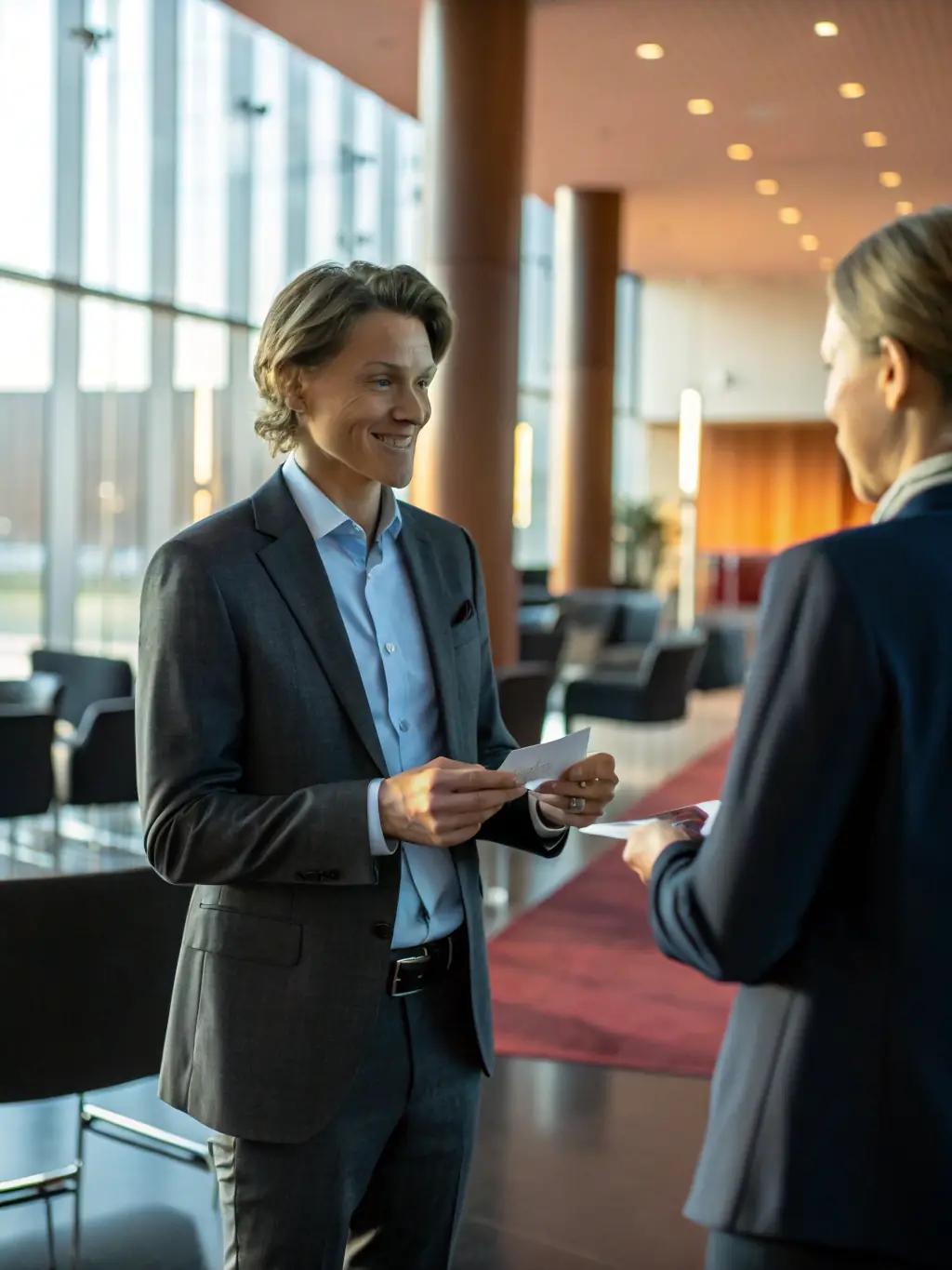 A dynamic image showcasing a networking session at a marketing conference, with professionals exchanging business cards and engaging in discussions.